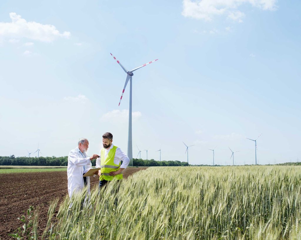 engineers-standing-on-wind-farm-making-notes-YSY6F6W-1.jpg